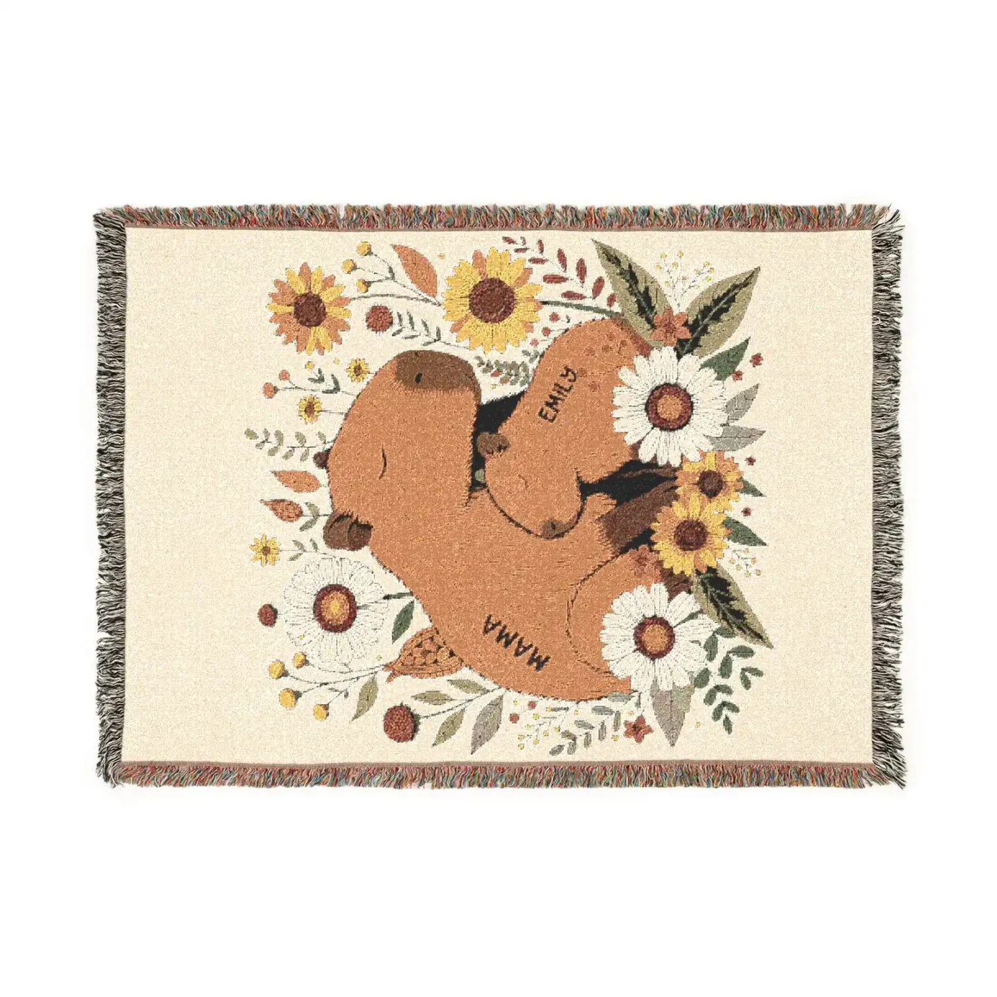 Flat lay of personalized capybara throw blanket showing mama and baby capybara with sunflowers and daisy botanical design, cream and amber palette