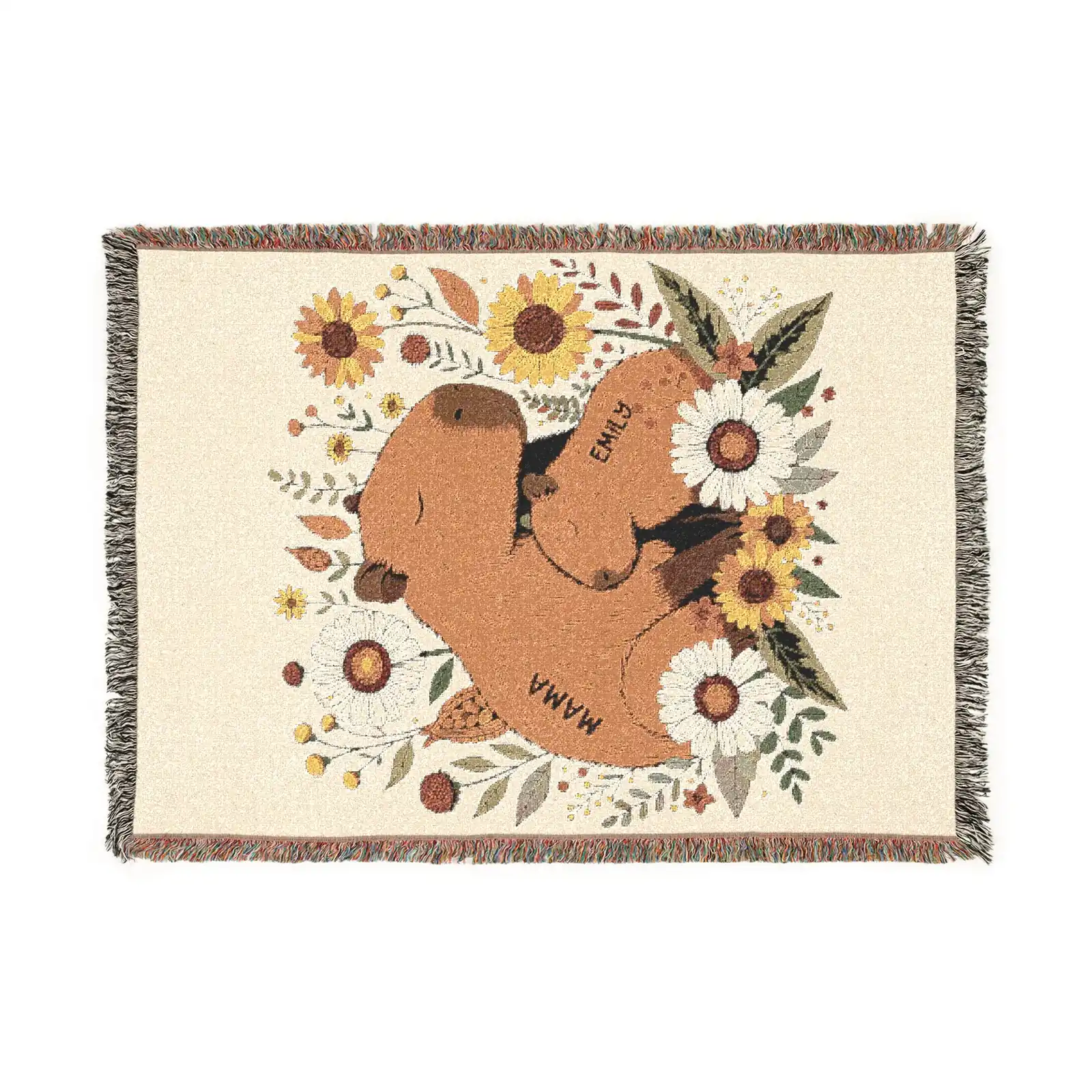 Flat lay of personalized capybara woven throw blanket showing mama and baby capybara with sunflowers and daisy botanical design, cream and amber palette